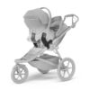 Pelēki bērnu ratiņi ar kulbu un sporta daļu, lieliem riteņiem un jumtiņu