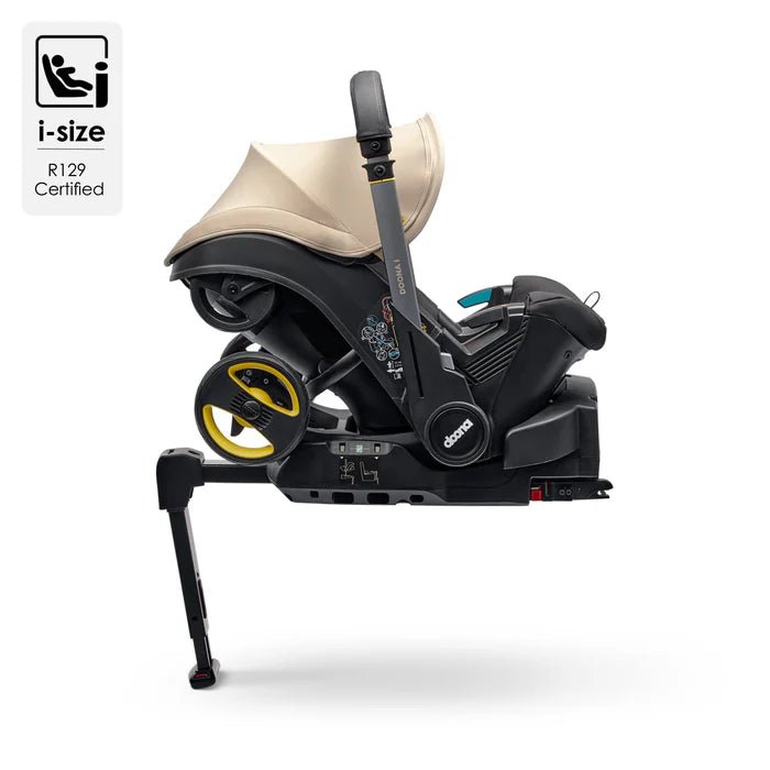 Doona_i_Isofix_Web_1600x1600_2_700x_9b3861b6-e366-486f-a74b-0f7f0eb3ddb7-1.jpg Doona i autokrēsliņš ar Isofix bāzi, melns un bēšs, ar balstu un riteņiem